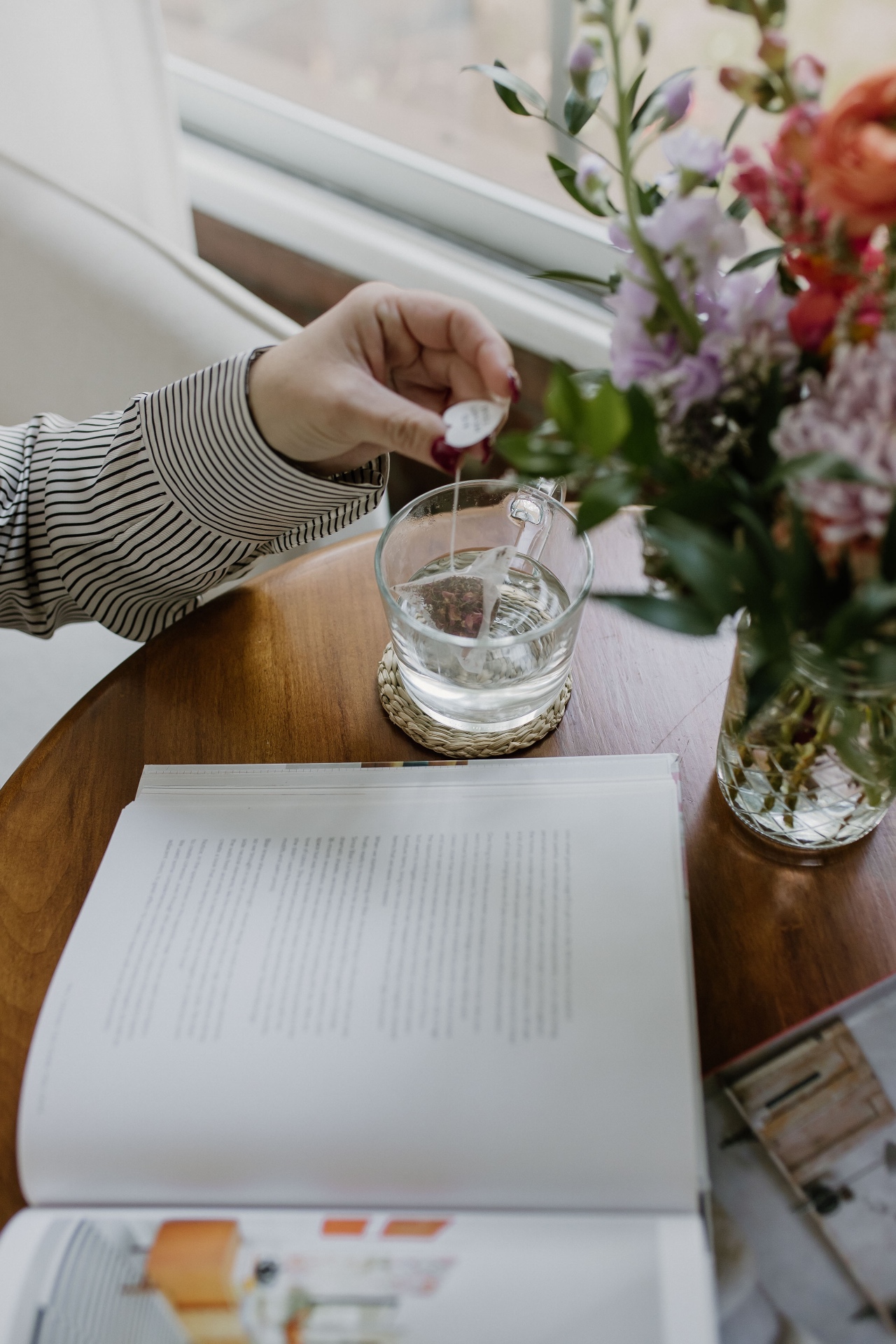 Tea and open book on a wooden table